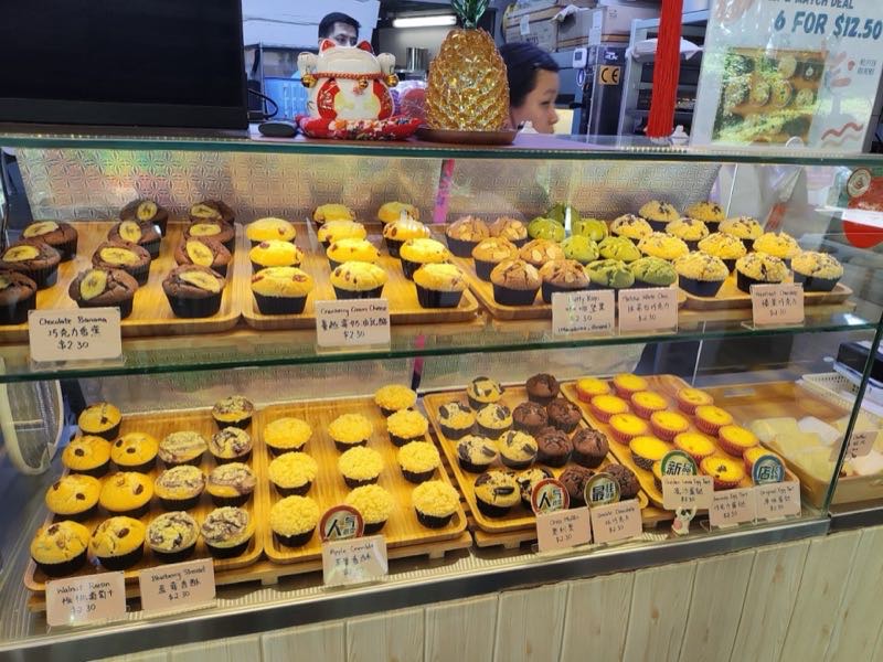 Muffin Homme stall display with fresh muffins and egg tarts